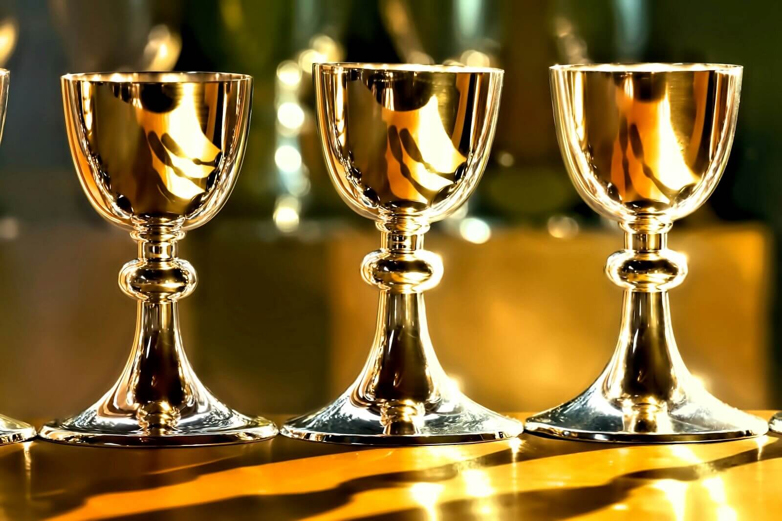 three gold chalice